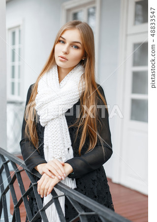 Beautiful girl in a white knitted scarf Beautiful girl in a white knitted scarf 48833547