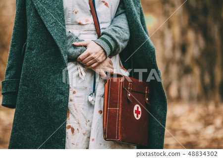Unidentified re-enactor wears historical German nurse paramedic Of World War II uniform 48834302