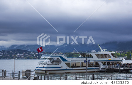 Boat on the Zurich Lake. Pier in Zurich Boat on the Zurich Lake. Pier in Zurich 48835270