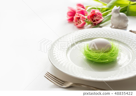 Easter table setting with pink tulip on white. Spring romantic dinner. Space for text. 48835422