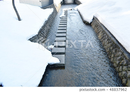 snow melting down fall to canal in Hokkaido Japan 48837962