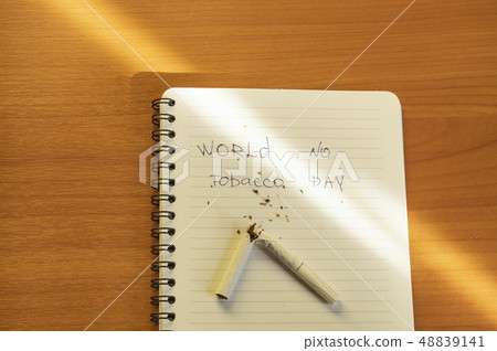 Flat lay, cigarettes and the inscription world no tobacco day written in a notebook, a healthy Flat lay, cigarettes and the inscription world no tobacco day written in a notebook, a healthy 48839141