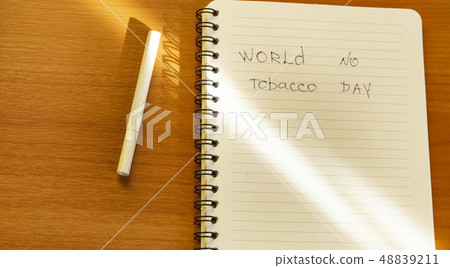 Flat lay, cigarettes and the inscription world no tobacco day written in a notebook, a healthy Flat lay, cigarettes and the inscription world no tobacco day written in a notebook, a healthy 48839211