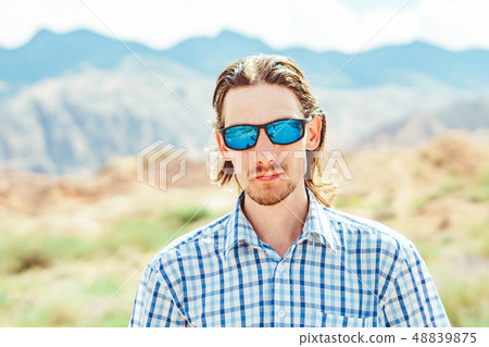 the guy standing on a background of mountains the guy standing on a background of mountains 48839875