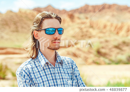 the guy standing on a background of mountains the guy standing on a background of mountains 48839877
