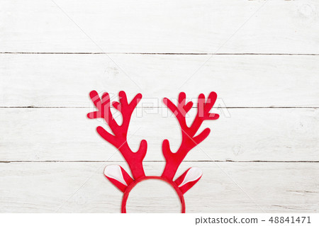 Toy antlers of a deer on white wooden background 48841471