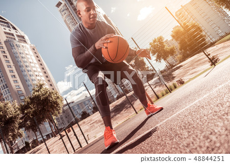 Nice active young man playing basketball game Nice active young man playing basketball game 48844251