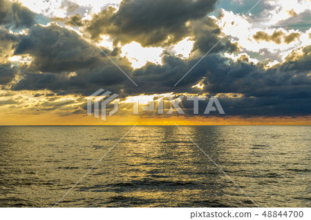 Sunflare through the clowds at the Ligurian sea Sunflare through the clowds at the Ligurian sea 48844700