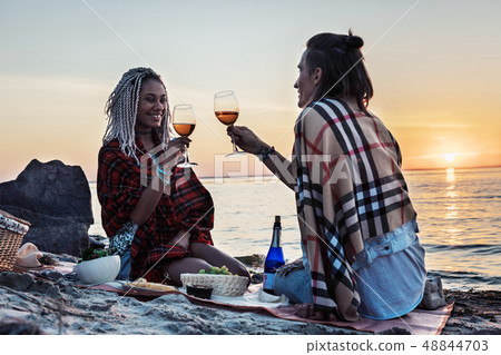 Beaming woman drinking champagne with her man having picnic 48844703