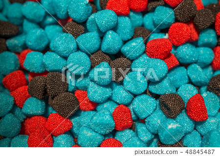 Blue black and red candies in the form of raspberries and blackberries Blue black and red candies in the form of raspberries and blackberries 48845487