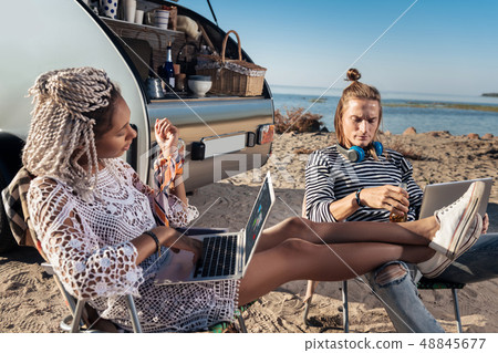 Blonde-haired man with weird hairstyle talking to his appealing girlfriend 48845677