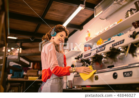 Positive delighted woman enjoying favorite music in headphones 48846027