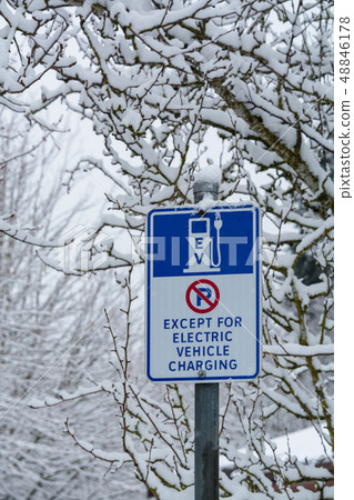 Road sign with EV charging station on snow background Road sign with EV charging station on snow background 48846178