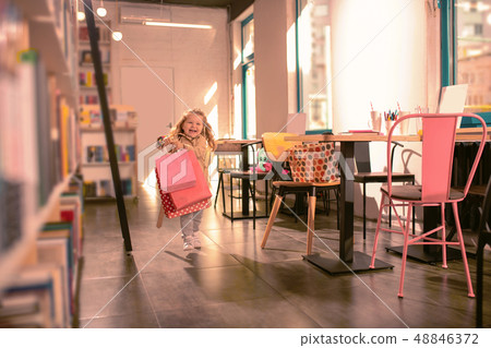 Amazing baby girl feeling happiness while being in cafe Amazing baby girl feeling happiness while being in cafe 48846372