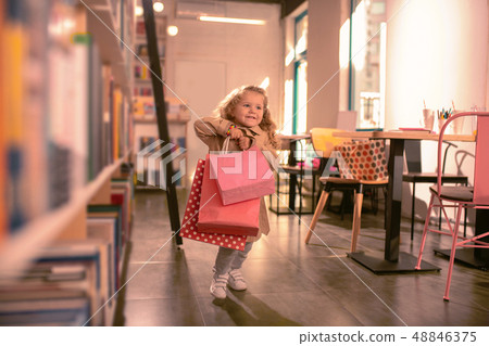 Happy little girl running with shopping bags 48846375