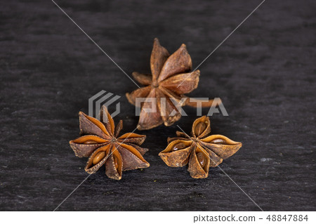 Dry brown star anise fruit on grey stone 48847884