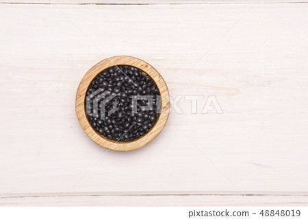 Black lentils beluga on grey wood Black lentils beluga on grey wood 48848019