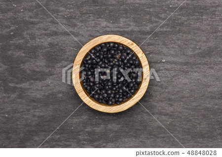 Black lentils beluga on grey stone 48848028
