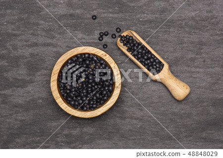 Black lentils beluga on grey stone Black lentils beluga on grey stone 48848029