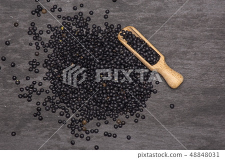 Black lentils beluga on grey stone Black lentils beluga on grey stone 48848031