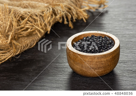 Black lentils beluga on grey stone 48848036