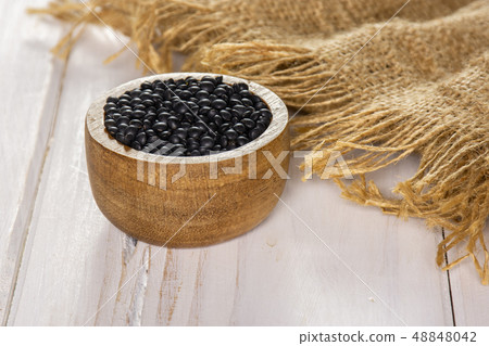 Black lentils beluga on grey wood Black lentils beluga on grey wood 48848042