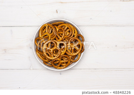 Mini salted pretzels on grey wood Mini salted pretzels on grey wood 48848226