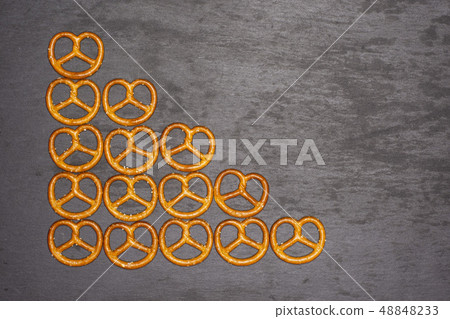 Mini salted pretzels on grey stone 48848233