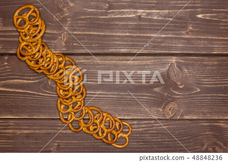 Mini salted pretzels on brown wood 48848236