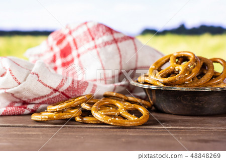 Mini salted pretzels with field behind Mini salted pretzels with field behind 48848269
