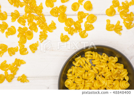 Raw pasta funghetto on grey wood Raw pasta funghetto on grey wood 48848400