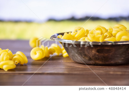 Raw pasta funghetto with field behind 48848414