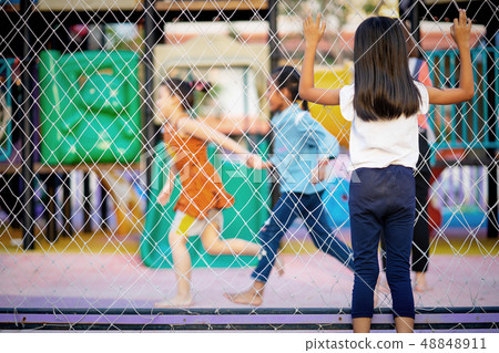child watching friends play at the playground 48848911