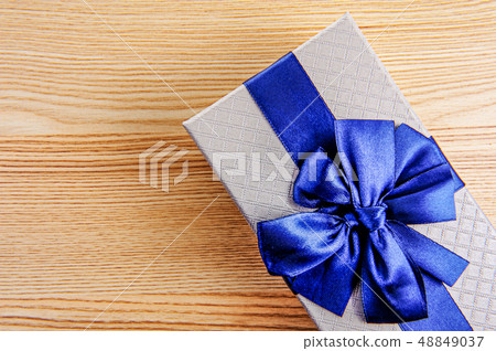 Silver gift box for new year on wooden background Silver gift box for new year on wooden background 48849037