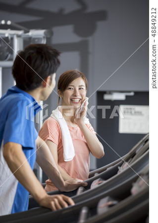Couple exercising in the gym Couple exercising in the gym 48849212