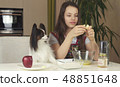 Teen girl with dog Papillon prepare cookies, knead the dough 48851648