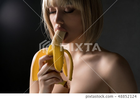 Nude blonde eating banana shot 48852124