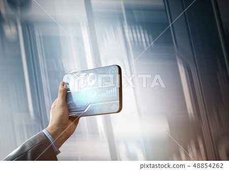 Media technology concept presented by businessman holding tablet with graphs and diagrams 48854262