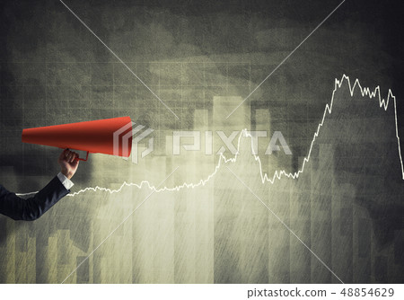 Hand of businesswoman holding red paper trumpet against graphs background 48854629