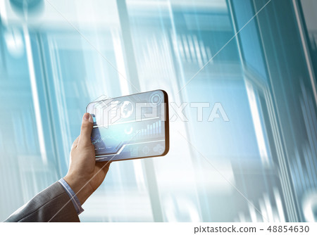Media technology concept presented by businessman holding tablet with graphs and diagrams 48854630