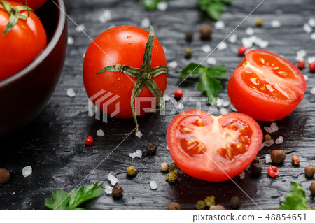 Fresh Sliced Cherry Tomatoes on a black background 48854651