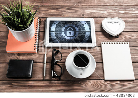 Web security and technology concept with tablet pc on wooden tab Web security and technology concept with tablet pc on wooden tab 48854808
