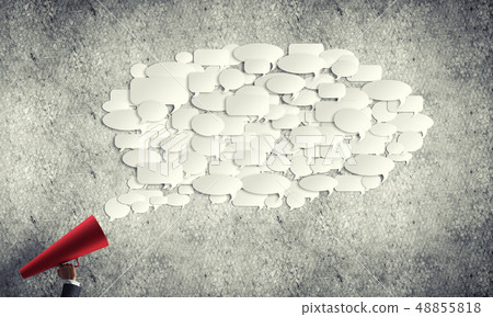 Hand of woman holding red paper trumpet against concrete background Hand of woman holding red paper trumpet against concrete background 48855818