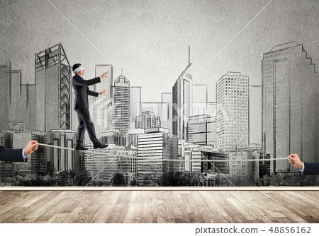 Business concept of risk support and assistance with man balancing on rope 48856162