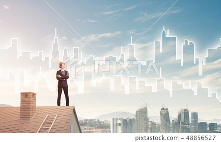 Engineer man standing on roof and looking away. Mixed media Engineer man standing on roof and looking away. Mixed media 48856527