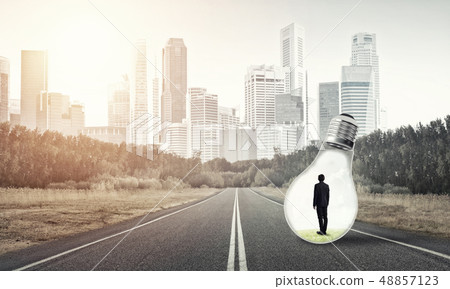 Businessman inside light bulb Businessman inside light bulb 48857123