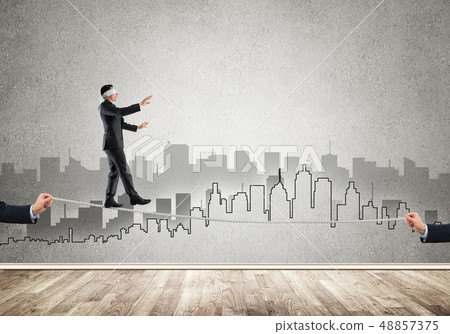 Business concept of risk support and assistance with man balancing on rope 48857375