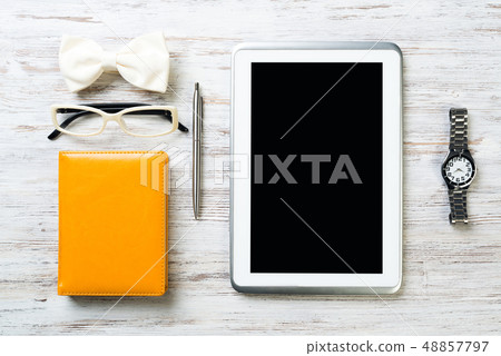 Gentleman kit of tablet watch glasses bow tie and notebook on wooden table Gentleman kit of tablet watch glasses bow tie and notebook on wooden table 48857797