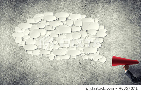 Hand of businesswoman holding red paper trumpet and speech cloud coming out Hand of businesswoman holding red paper trumpet and speech cloud coming out 48857871