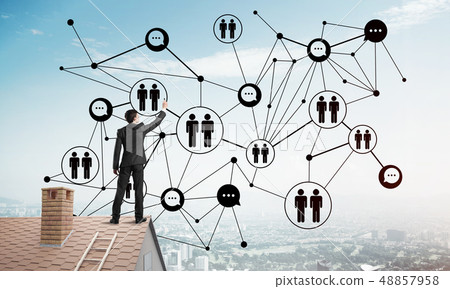 Businessman on house roof presenting networking and connection concept. Mixed media Businessman on house roof presenting networking and connection concept. Mixed media 48857958